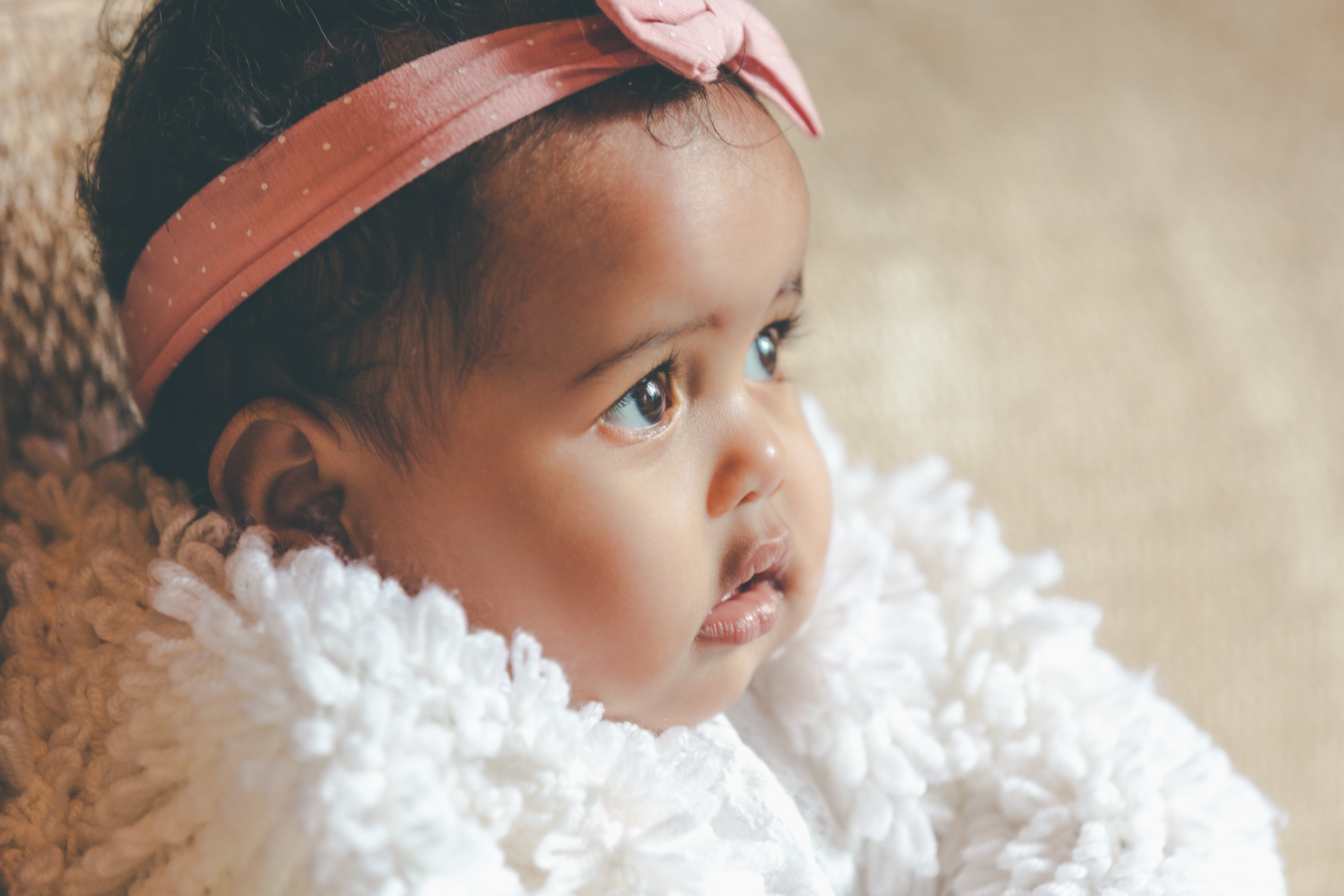 Cute baby girl with pink bow headband